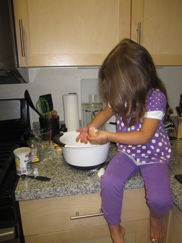 A young Ella baking in the kitchen